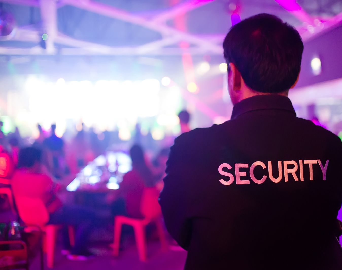 Professional event security officer monitoring a concert and nightlife venue for crowd control - Tiger Elite Security